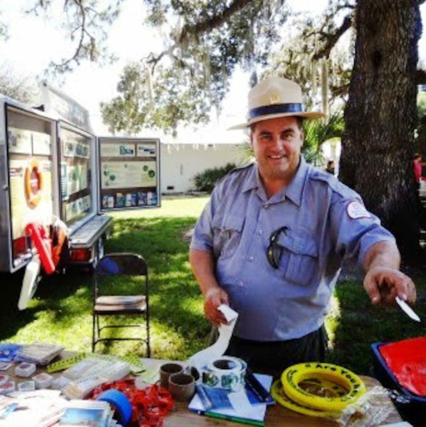 Brian Scott Older, a park ranger at the W.P. Franklin Recreation Area near Alva, provides water safety information to families at LaBelle's Kiwanis Kids Day in both English and Spanish.