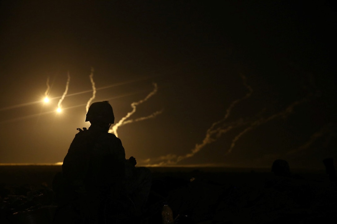 A U.S. Marine with Weapons Company, Battalion Landing Team 2nd Battalion, 1st Marines, 11th Marine Expeditionary Unit (MEU), watches 81mm illumination mortar rounds fall during a joint mortar range with Royal Saudi Naval Forces Marines with the 3rd Marine Infantry Battalion during exercise Red Reef 15 in the U.S. 5th Fleet area of responsibility, Dec 12, 2014. Red Reef is part of a routine theater security cooperation engagement plan between the U.S. Navy, U.S. Marine Corps and Royal Saudi Naval Forces that serves as an excellent opportunity to strengthen tactical proficiency in critical mission areas and support long-term regional security.
 (U.S. Marine Corps photo by Cpl. Jonathan R. Waldman/Released)
