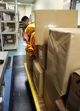 Marines at the Mainside Postal Office aboard Marine Corps Air Station Iwakuni, Japan, continue to push through the demanding overload of mail during the busiest time of the year. More than 700 pounds of mail are sent per day and 3,500 pounds of mail are received per day during the busy holiday season months of late November to mid-January.

