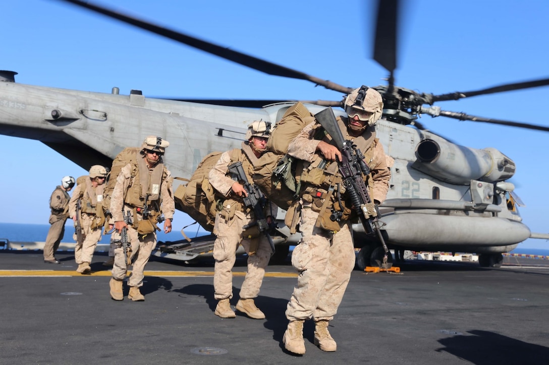 Marines with Golf Company, Battalion Landing Team 2nd Battalion, 1st Marines, 11th Marine Expeditionary Unit (MEU), off-load from a CH-53E Super Stallion with Marine Medium Tiltrotor Squadron 163 (Reinforced), 11th MEU, aboard the amphibious assault ship USS Makin Island (LHD 8), Dec. 12. The Makin Island Amphibious Ready Group (ARG) and the embarked 11th Marine Expeditionary Unit are deployed in support of maritime security operations and theater security cooperation efforts in the U.S. 5th Fleet area of responsibility. 