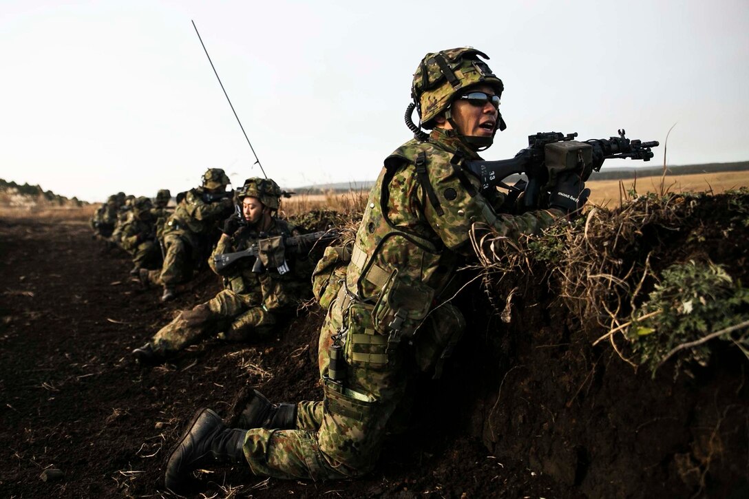 Japan Ground Self-Defense Force members engage in a simulated firefight Dec. 9 during Forest Light 15-1 at the Oyanohara Training Area in Yamato, Kumamoto prefecture, Japan. Forest Light is a routine, semi-annual exercise designed to enhance the U.S. and Japan military partnership, solidify regional security agreements and improve individual and unit-level skills. The JGSDF members are with 42nd Regiment, 8th Division, Western Army.  