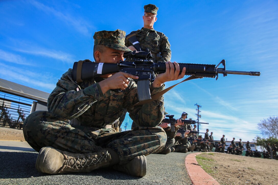 Recruit Bryan A. Soberaniperez, Platoon 1049, Charlie Company, 1st Recruit Training Battalion, sights in during “snap-in-time” at Marine Corps Base Camp Pendleton,Calif., Nov. 24. The instructors gave recruits “snap-in-time” so they could practice the different position and fundamentals they were taught. During “snap-in-time,” recruits aimed in at barrels with targets painted on them simulating the targets at different yard lines.