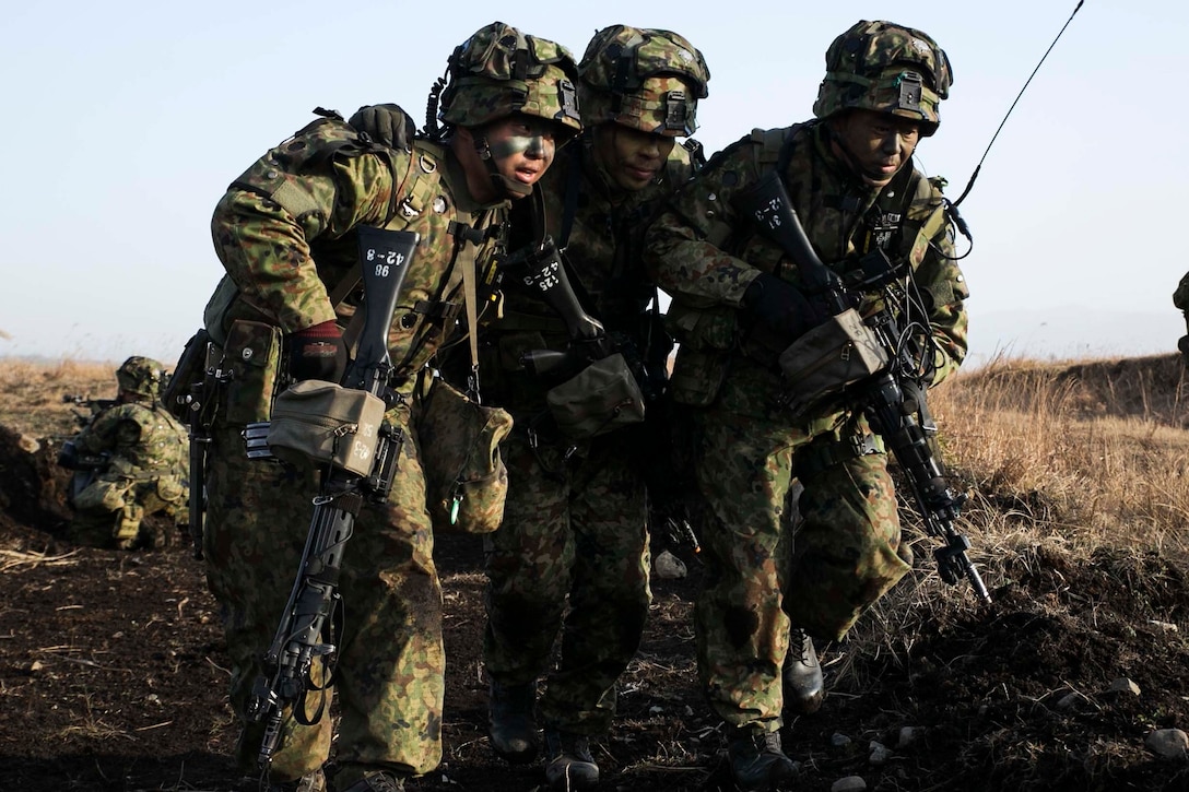 Japan Ground Self-Defense Force members move a mock wounded comrade to safety Dec. 9 during Forest Light 15-1 at the Oyanohara Training Area in Yamato, Kumamoto prefecture, Japan. Forest Light is a routine, semi-annual exercise designed to enhance the U.S. and Japan military partnership, solidify regional security agreements and improve individual and unit-level skills. The JGSDF members are with 42nd Regiment, 8th Division, Western Army. 