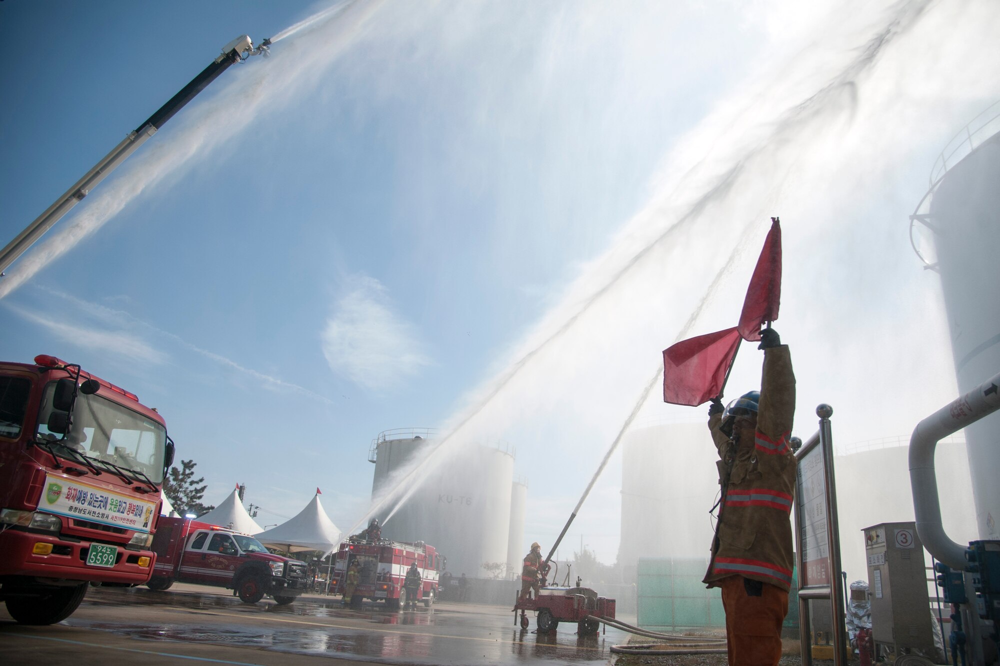 Kunsan Air Base firefighters, alongside Gunsan City firefighters, extinguish a simulated fire during an emergency-relief exercise in Gunsan City, Republic of Korea, Nov. 5, 2014. The purpose of the exercise was to establish an incident command system between multiple organizations and enhance their ability to respond to emergencies and large disasters. (U.S. Air Force photo by Senior Airman Taylor Curry/Released) 