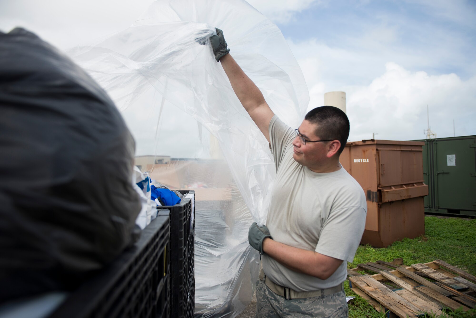Tech. Sgt. Miguel Vasquez covers a sorted crate of donations for Operation Christmas Drop at Andersen Air Base, Guam, Dec. 3, 2014. The donations were sorted into crates, covered to protect from weather damage and then sent on to a hangar where they would later be divided into individual bundles destined for islands in the Pacific. Vasquez is with the 515th Combat Mobility Flight at Yokota Air Base, Japan. (U.S. Air Force photo by Staff Sgt. Cody H. Ramirez/Released)