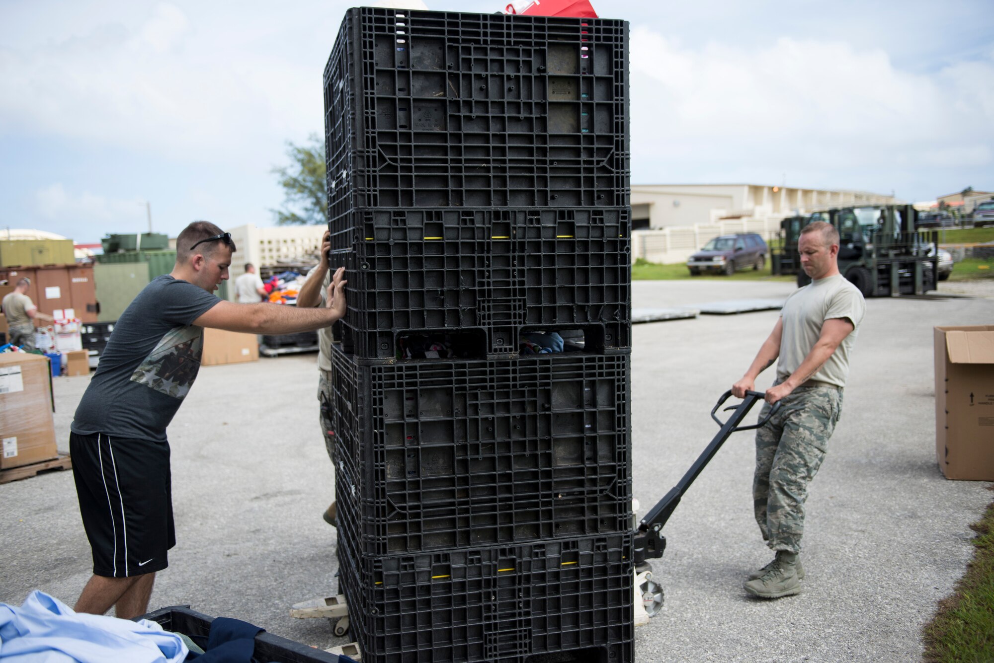 Airman 1st Class James Kephart, 644 Combat Communication Squadron, pushes crates of organized donations for Operation Christmas Drop at Andersen Air Force Base, Guam, Dec. 03, 2014. The sorted crates expedited the process for building bundles destined for islands in Micronesia. (U.S. Air Force photo by Staff Sgt. Cody H. Ramirez/Released)