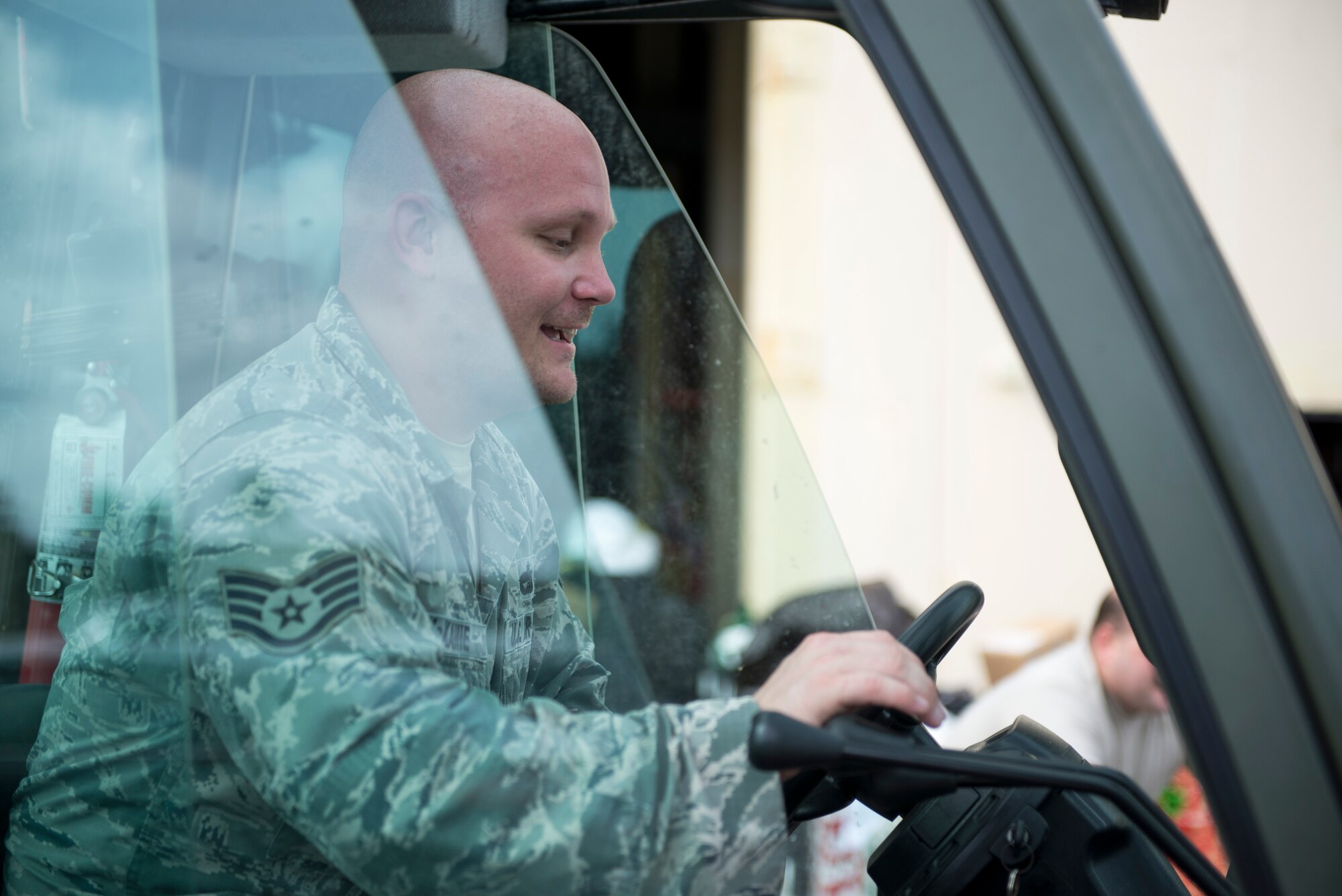 Staff Sgt. Matthew McKamie, 734th Air Mobility Squadron, moves crates filled with donations for Operation Christmas Drop at Andersen Air Force Base, Guam, Dec. 3, 2014. More than 50,000 pounds of donations were collected this year to be delivered to Micronesian islands. (U.S. Air Force photo by Staff Sgt. Cody H. Ramirez/Released)