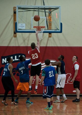 A member of the 57th Operations Support Squadron goes up for a layup during an intramural basketball game against the 99th Security Forces Squadron at Nellis Air Force Base, Nev., Dec. 15, 2014. Trailing by 12 at the end of the first half, the 57th OSS’ deficit reached 25 before they cut the lead to 10 and ultimately fell 61-44 to the 99th SFS. The 99th SFS’ victory improves their record to 1-1 for this year’s intramural basketball season, which kicked off Dec. 8. (U.S. Air Force photo by Staff Sgt. Siuta B. Ika)