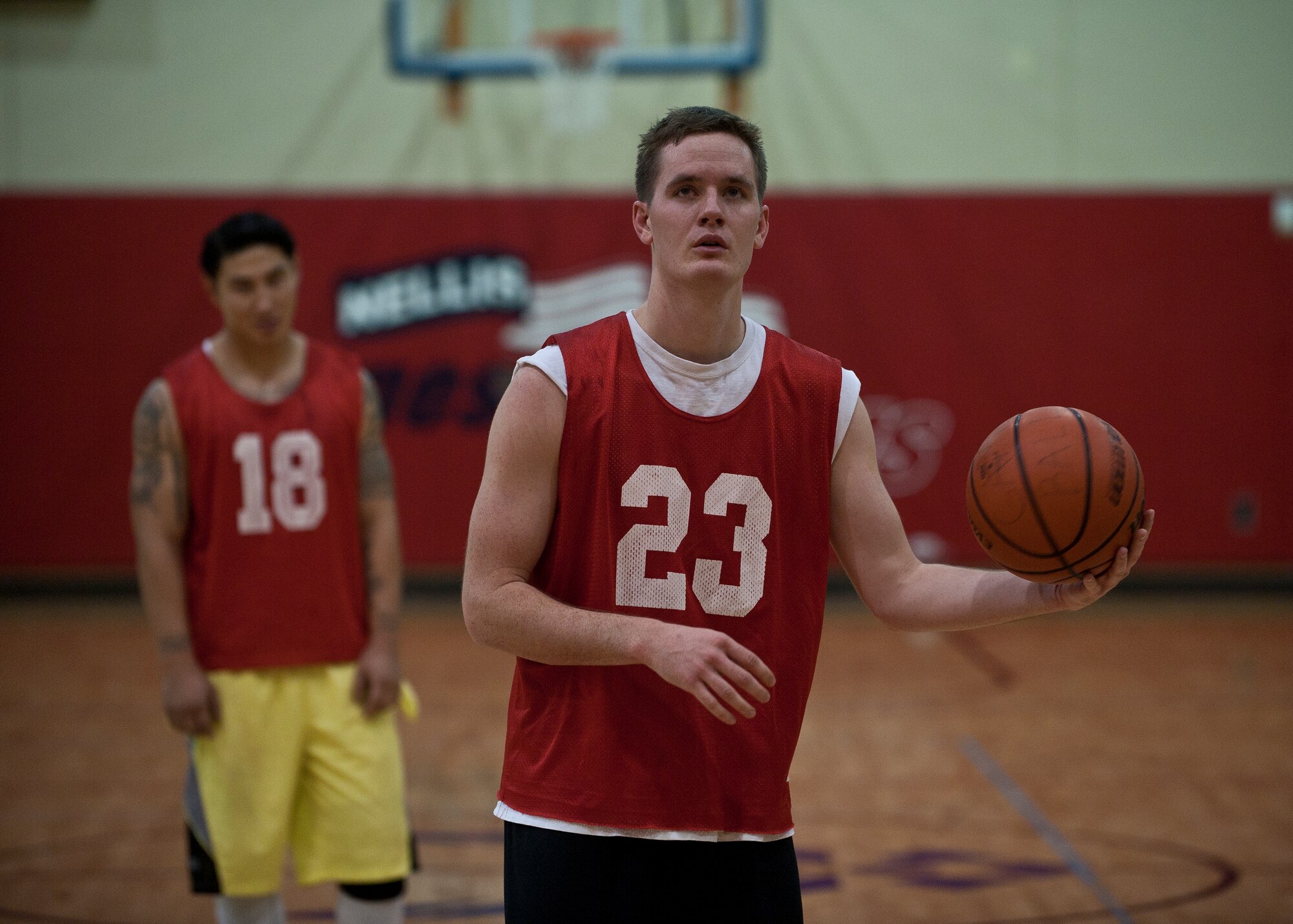 A member of the 57th Operations Support Squadron prepares to shoot a free throw during an intramural basketball game against the 99th Security Forces Squadron at Nellis Air Force Base, Nev., Dec. 15, 2014. After being held to 15 points in the first half, the 57th OSS exploded for 29 in the second but still fell to the 99th SFS 61-44. Seventeen teams are vying for this year’s intramural basketball title. (U.S. Air Force photo by Staff Sgt. Siuta B. Ika)