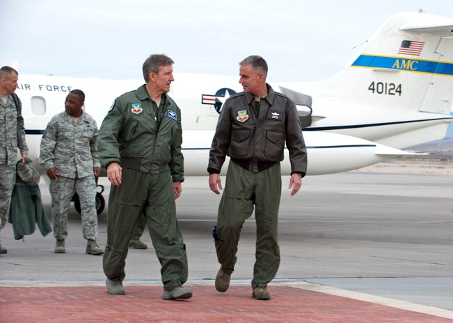 Gen. Hawk Carlisle, Air Combat Command commander, is greeted by and talks with Maj. Gen. Jay Silveria, U.S. Air Force Warfare Center commander, after arriving at Nellis Air Force Base, Nev., Dec. 11, 2014. Carlisle attended the U.S. Air Force Weapons School graduation ceremony as the guest speaker. (U.S. Air Force photo by Senior Airman Thomas Spangler)