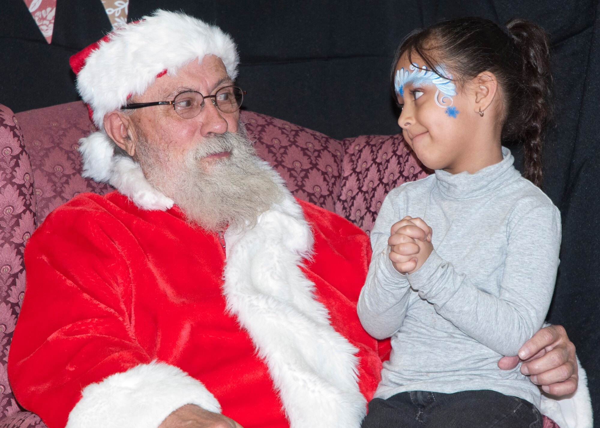 A child negotiates with Santa Claus during Operation Provide Joy in the Fall Hall Community Center on F.E. Warren Air Force Base, Wyo., Dec. 13, 2014. Meeting Santa was the last main event the children in Operation Provide Joy participated in and was the highlight of the day. (U.S. Air Force photo/Airman 1st Class Malcolm Mayfield)