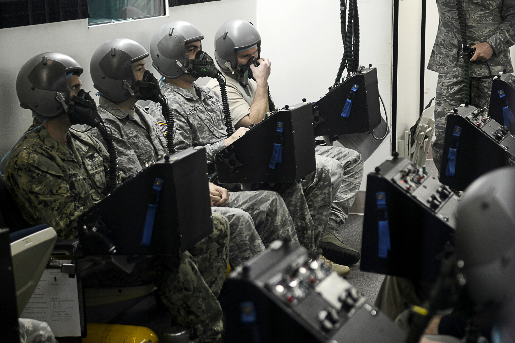 U.S. Service members train to recognize and mitigate symptoms of hypoxia in the hypobaric chamber at Langley Air Force Base, Va., Dec. 11, 2014. The hypobaric chamber changes air pressure and chemistry to simulate different heights in altitude to train pilots and aircrew members to handle the physiological stresses of fights. (U.S. Air Force photo by Airman 1st Class Devin Scott Michaels/Released)