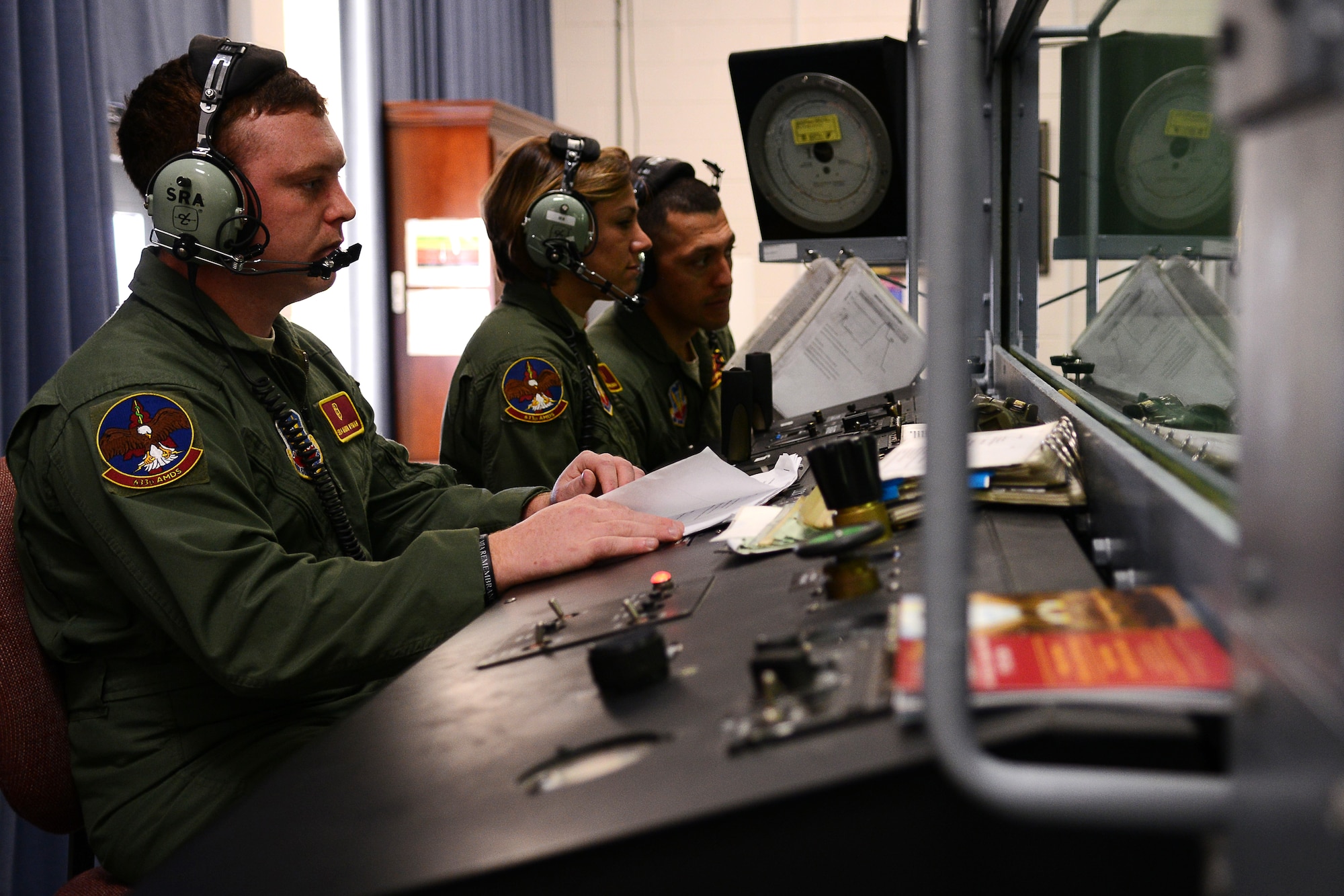 U.S. Air Force Airmen from the 633rd Aerospace Medical Squadron help operate the hypobaric chamber for the last time before implementing use of the new Reduced Oxygen Breathing Devices at Langley Air Force Base, Va., Dec. 11, 2014. The new system will require less technicians to train students, saving time and money. (U.S. Air Force photo by Airman 1st Class Devin Scott Michaels/Released)