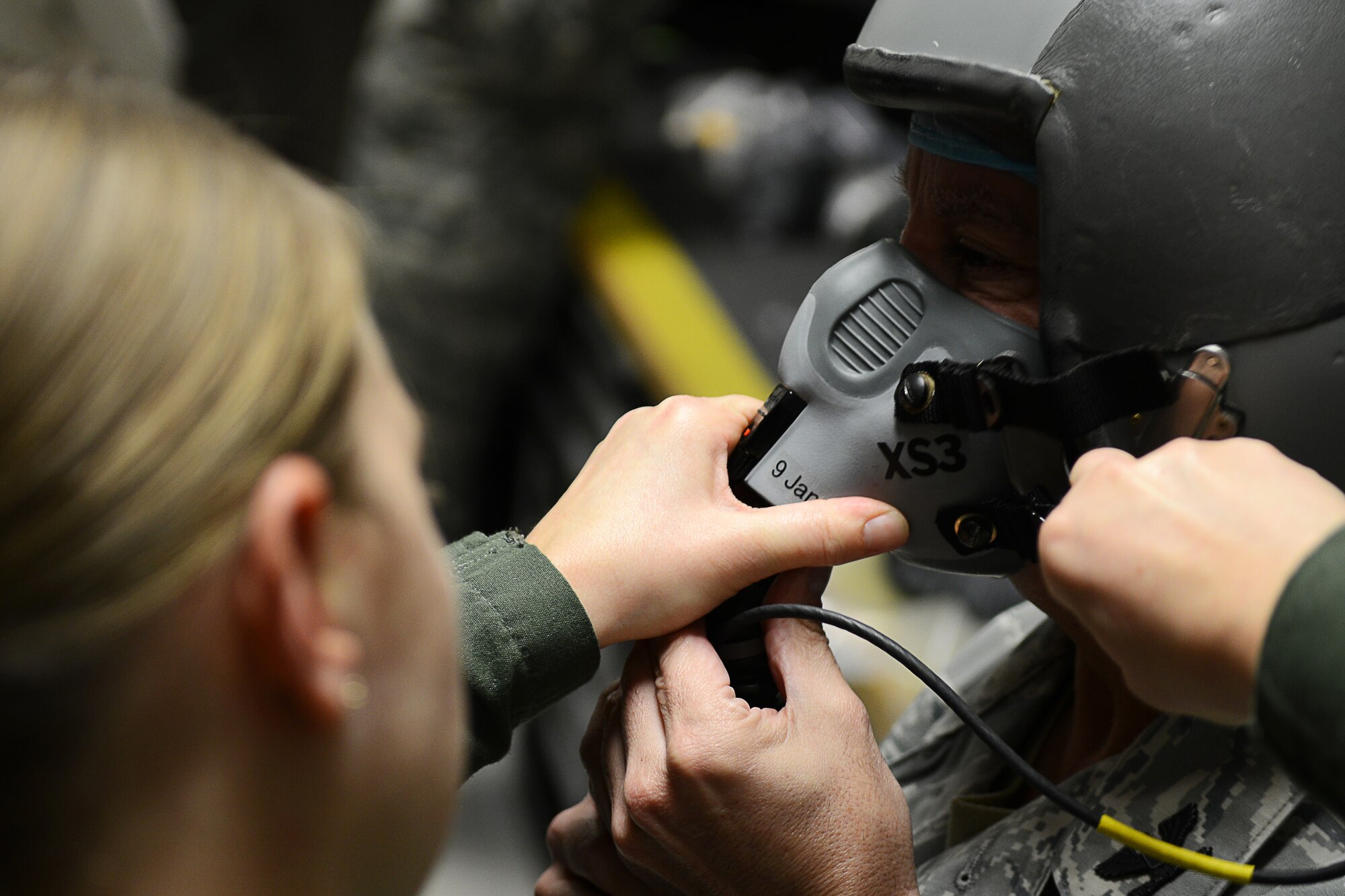 U.S. Air Force Tech. Sgt. Isis Lovette, 633rd Aerospace Medical Squadron operations noncommissioned officer in charge, prepares Col. James Forrest, 633rd Medical Group vice group commander, for training in the hypobaric chamber at Langley Air Force Base, Va., Dec. 11, 2014. The U.S. Air Force uses hypobaric chambers and Reduced Oxygen Breathing Devices to train Service members how to recognize and endure the symptoms of hypoxia in a life-or-death situation. (U.S. Air Force photo by Airman 1st Class Devin Scott Michaels/Released)