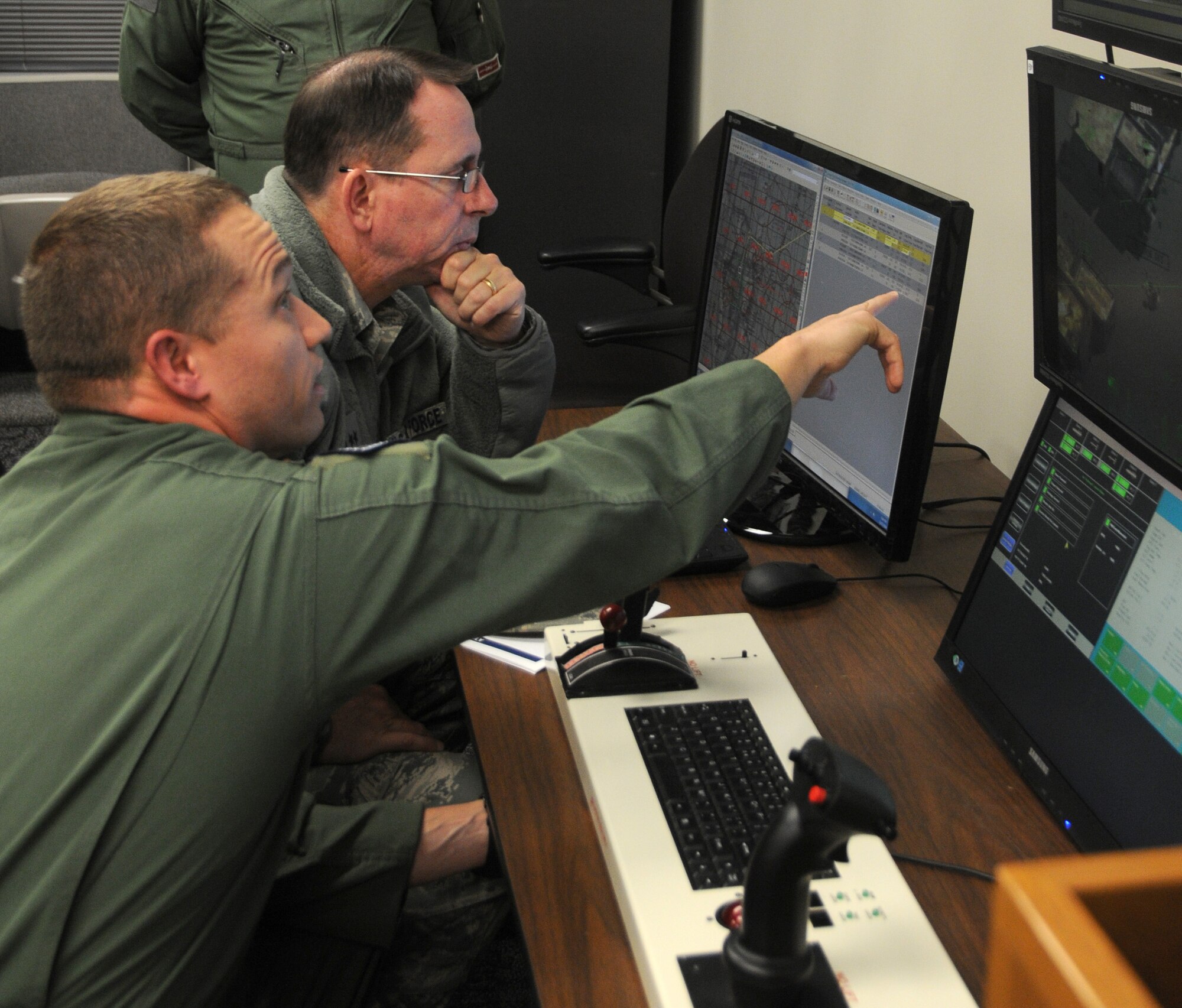 Maj. Gen. John Shanahan is briefed by a member of the 184th Attack Squadron at Ebbing Air National Guard Base, Fort Smith, Ark., Dec. 11, 2014. Shanahan’s visit encompassed seeing and understanding how the wing’s new mission aligns with the 25th AF. (U.S. Air National Guard photo by Airman 1st Class Cody Martin/released)
