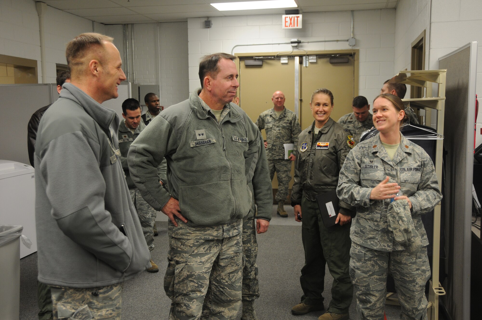 Maj. Sara Stigler, commander of the 153rd Intelligence Squadron, speaks with Maj. Gen. John Shanahan, commander of the 25th Air Force, at Ebbing Air National Guard Base, Fort Smith, Ark., Dec. 11, 2014. Shanahan’s visit encompassed seeing and understanding how the wing’s new mission aligns with the 25th AF. (U.S. Air National Guard photo by Airman 1st Class Cody Martin/released)