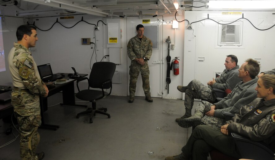 Tech Sgt. Robert Ellis, joint terminal attack controller trainer, speaks with Maj. Gen. John Shanahan, commander of the 25th Air Force, at the 188th Wing Detachment 1 Razorback Range, Fort Chaffee Joint Maneuver Training Center, Ark., Dec. 11, 2014. Shanahan’s visit encompassed seeing and understanding how the wing’s new mission aligns with the 25th AF. (U.S. Air National Guard photo by Airman 1st Class Cody Martin/released)