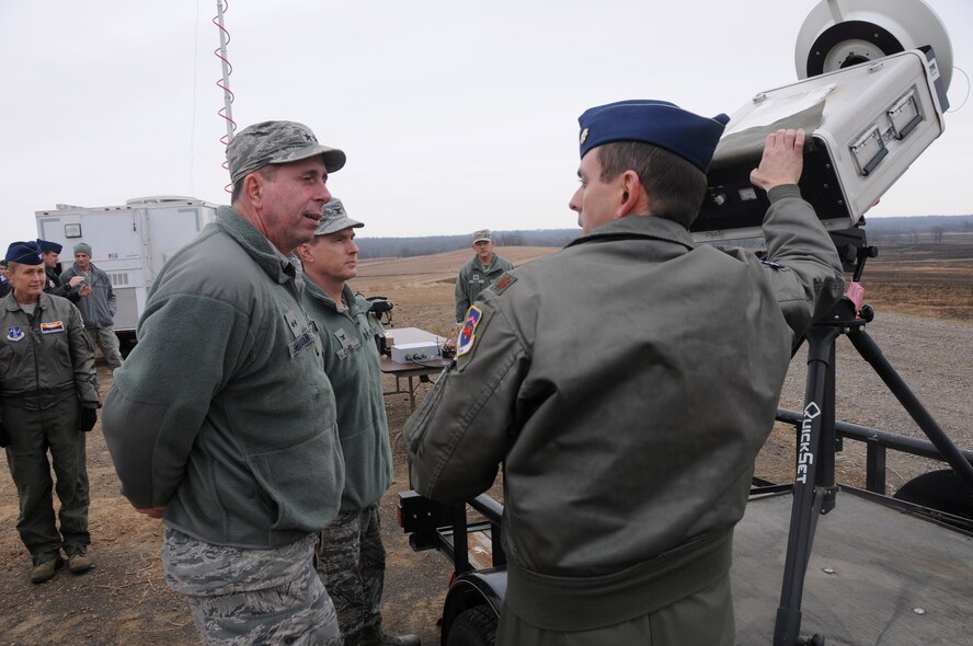 Maj. Doug Davis, 188th Wing Detachment 1 Razorback Range commander, shows Maj. Gen. John Shanahan, commander of the 25th Air Force, the AN/UPQ-8(V) Single Ground Threat Emitter at Ebbing Air National Guard Base, Fort Smith, Ark., Dec. 11, 2014. The AN/UPQ-8(V) Single Ground Threat Emitter is a radar threat simulator used in land, air and sea environments simulating frequency characteristics of certain hostile missiles, anti-aircraft artillery and ground radar sites. Shanahan’s visit encompassed seeing and understanding how the wing’s new mission aligns with the 25th AF. (U.S. Air National Guard photo by Airman 1st Class Cody Martin/released)