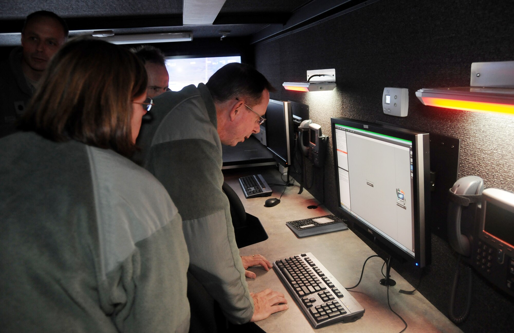 Maj. Gen. John Shanahan, commander of the 25th Air Force at Joint Base San Antonio-Lackland, Texas, looks at a computer monitor in the remote air, zonal operations, reach back-processing, assessment and dissemination trailer at the 188th Wing Detachment 1 Razorback Range, Fort Chaffee Joint Maneuver Training Center, Ark., Dec. 11, 2014. Shanahan’s visit encompassed seeing and understanding how the wing’s new mission aligns with the 25th AF. (U.S. Air National Guard photo by Airman 1st Class Cody Martin/released)