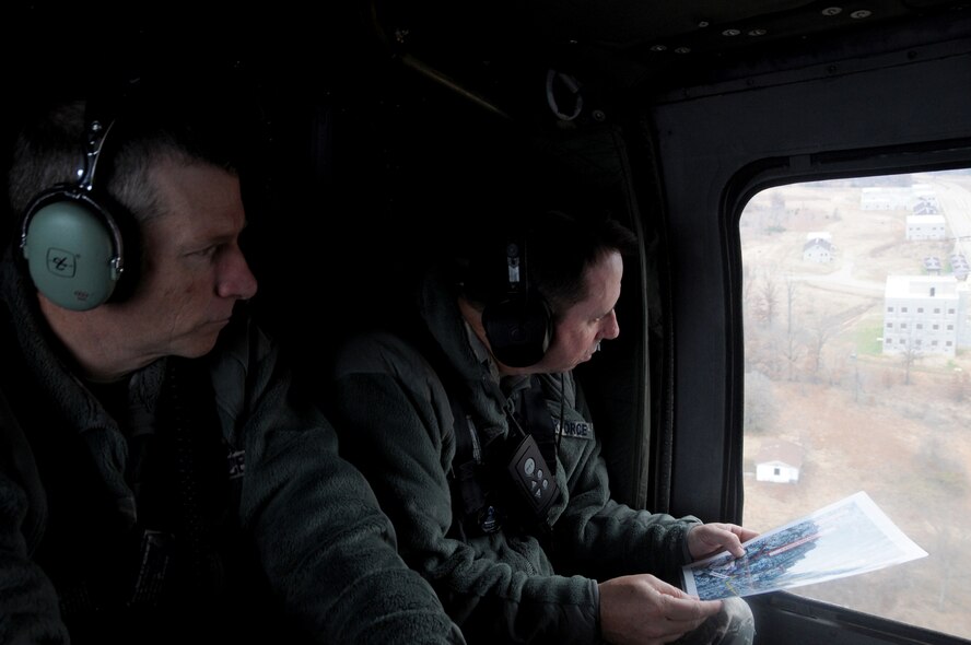 Maj. Gen. John Shanahan, commander of the 25th Air Force at Joint Base San Antonio-Lackland, Texas, and Col. Mark Anderson, commander of the 188th Wing, look out of the window of a UH-60 Black Hawk over Fort Smith, Ark., Dec. 11, 2014. Shanahan’s visit encompassed seeing and understanding how the wing’s new mission aligns with the 25th AF. (U.S. Air National Guard photo by Airman 1st Class Cody Martin/released)