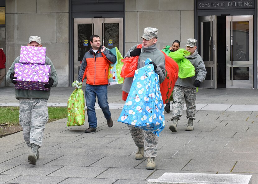 Pennsylvania National Guard members load gifts onto trucks outside of the Keystone Building, Harrisburg, Pennsylvania, Dec. 10, 2014, during the 25th Annual Holiday Wish Program gift drive. The guardsmen delivered the gifts to participating county assistance offices for distribution to more than 300 families. (U.S. Air National Guard photo by Tech. Sgt. Culeen Shaffer/Released)