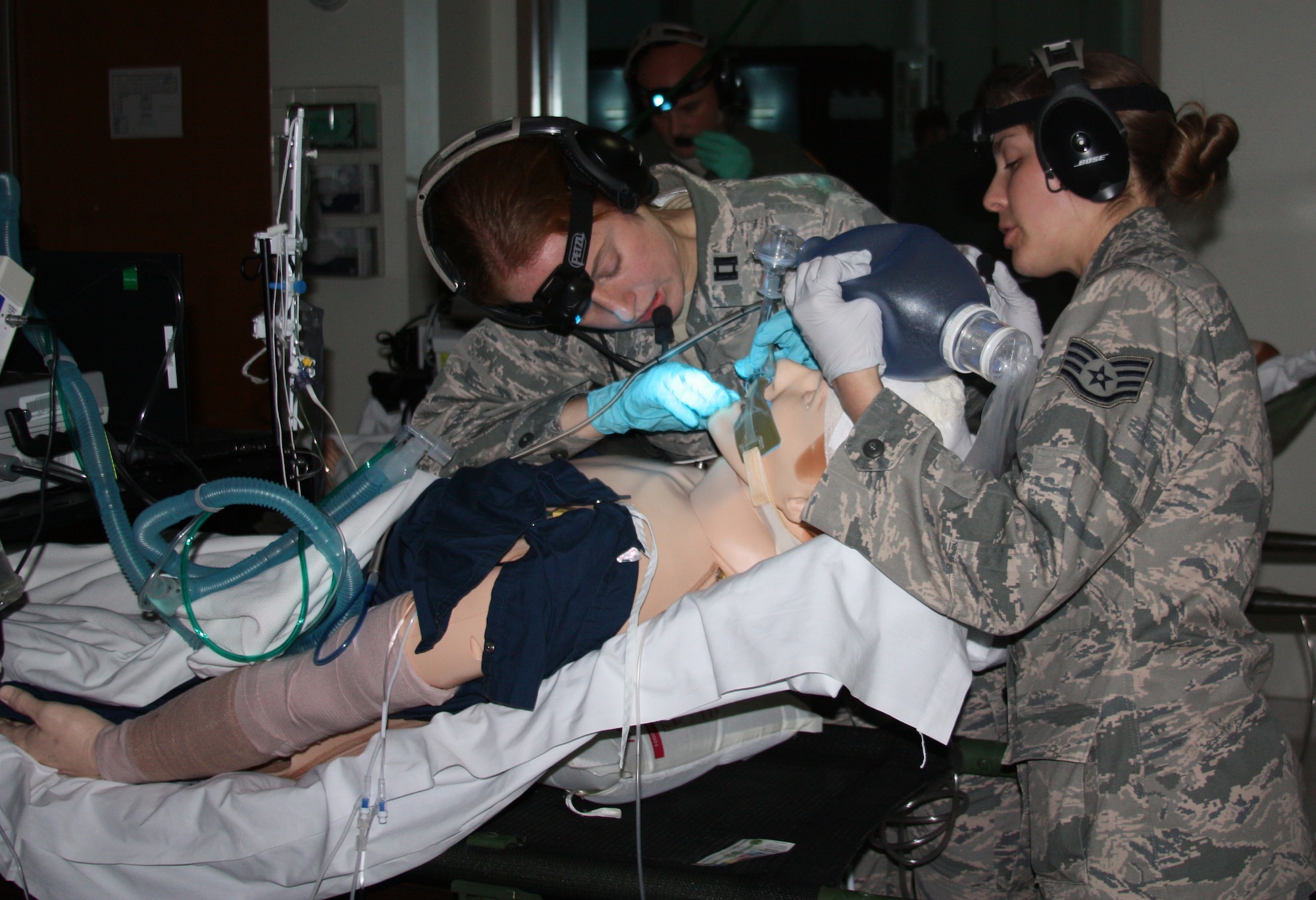 Capt. (Dr.) Katherine Ellis and Staff Sgt. Jamie Bucher provide critical care to "a patient" during Critical Care Air Transport Team (CCATT)Simulation Day training in Walter Reed Bethesda simulation center on Dec. 11. Air Force physicians, nurses and respiratory therapists were able to hone their critical care skills on life-like manikins using virtual reality machines and equipment in the high-tech, state-of-the-art simulation center. (Photo by Bernard S. Little)