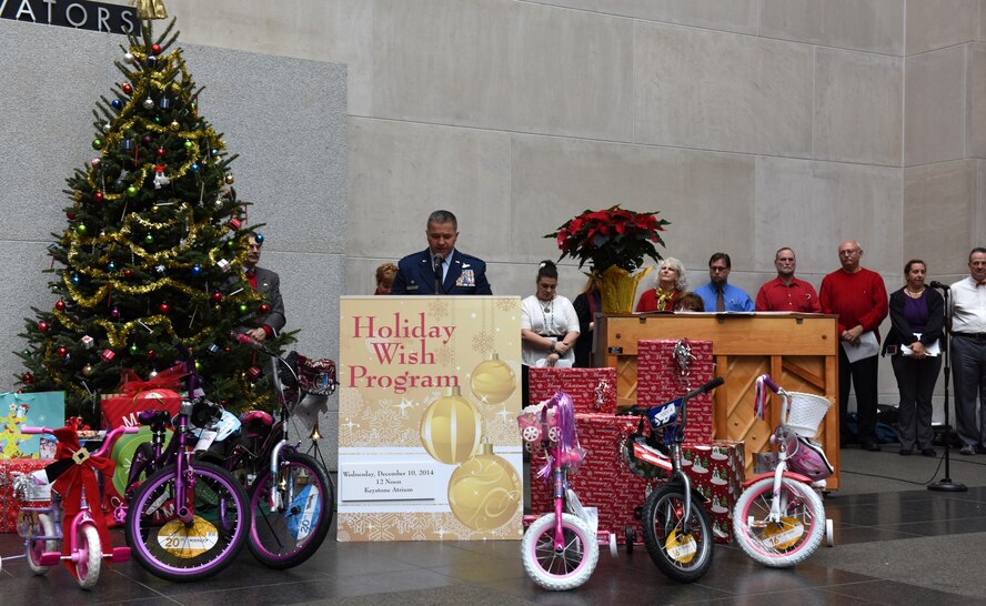 Col. John Dickinson, 193rd Special Operations Wing commander speaks at the 25th Annual Holiday Wish Program gift drive held at the Keystone Building, Harrisburg, Pennsylvania, Dec. 10, 2014. The drive provides more than 300 Pennsylvania families in need with gifts, donated by state employees. (U.S. Air National Guard photo by Tech. Sgt. Culeen Shaffer/Released)