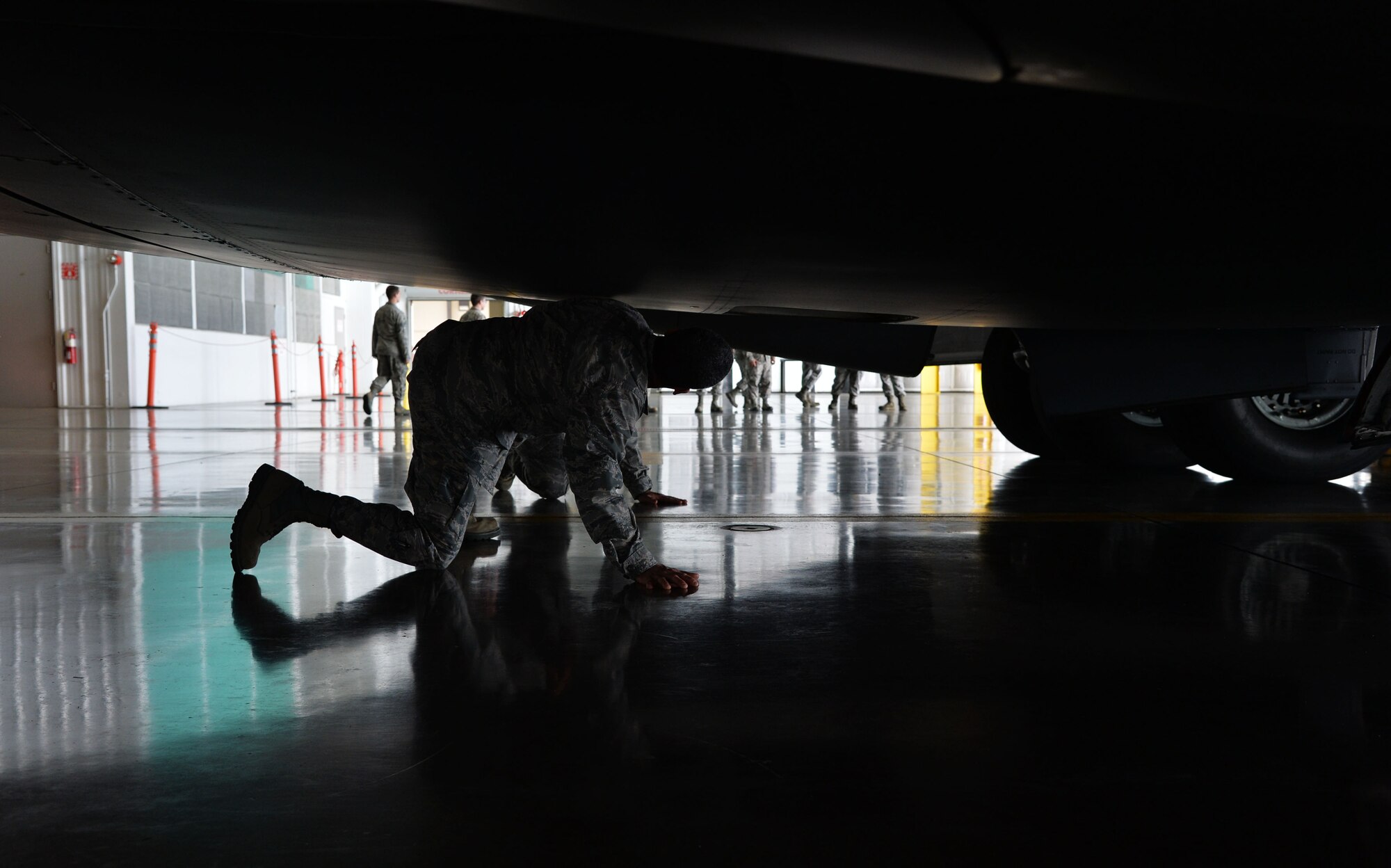 Lt. Gen. Russell Handy, 11th Air Force commander, checks out the underbelly of a C-17 Globemaster III during a tour of a 15th Aircraft Maintenance Squadron hangar at Joint Base Pearl Harbor-Hickam, Hawaii, Dec. 12, 2014. In addition to his tour, Handy also hosted a Wing all-call, addressing Air Force and Pacific region topics of interest. (U.S. Air Force photo by Staff Sgt. Alexander Martinez/Released)      