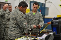 Senior Airman Brandon Turner, 15th Maintenance Squadron, shows Lt. Gen. Russell Handy, 11th Air Force commander, tools that Turner and his maintenance team use to repair aircraft during his tour of the 15th Wing at Joint Base Pearl Harbor-Hickam, Hawaii, Dec. 12, 2014. In addition to his tour, Handy also hosted a Wing all-call, addressing Air Force and Pacific-region topics of interest. (U.S. Air Force photo by Staff Sgt. Alexander Martinez/Released)      