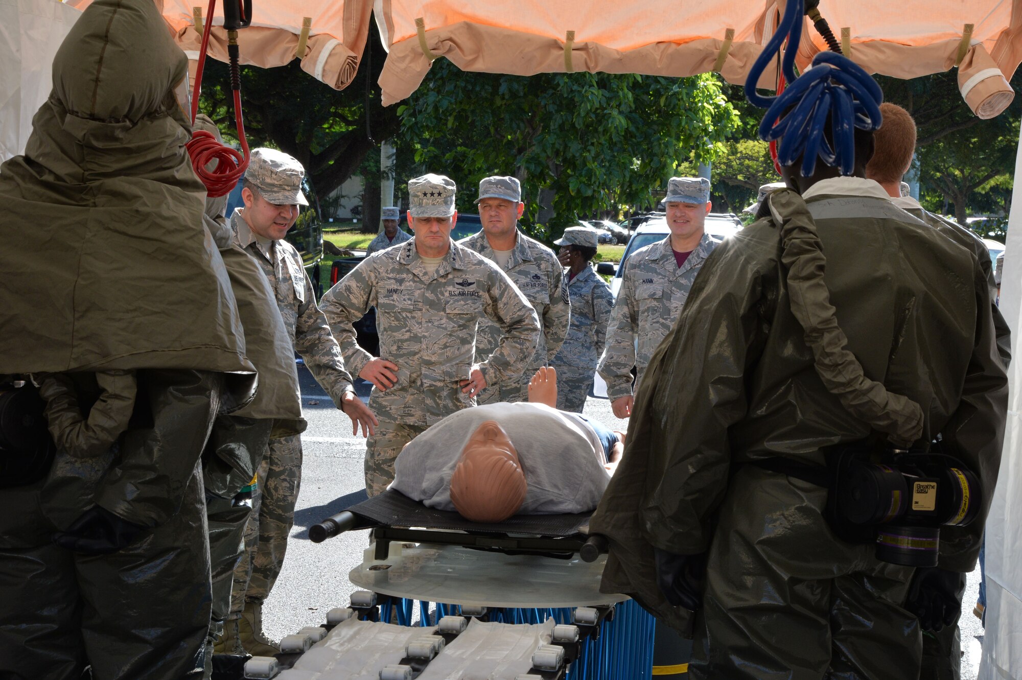 Lt. Gen. Russell Handy, 11th Air Force commander, receives a mass decontamination brief by 15th Medical Group members at Joint Base Pearl Harbor-Hickam, Hawaii, Dec. 12, 2014. During his visit, Handy hosted a Wing all-call, met with group and squadron leadership and toured base units. (U.S. Air Force photo by Staff Sgt. Alexander Martinez/Released)      