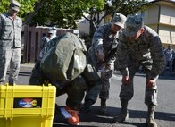 Lt. Gen. Russell Handy (right), 11th Air Force commander, receives a mass decontamination brief by 15th Medical Group members at Joint Base Pearl Harbor-Hickam, Hawaii, Dec. 12, 2014. During his visit, Handy hosted a Wing all-call, met with group and squadron leadership and toured base units. (U.S. Air Force photo by Staff Sgt. Alexander Martinez/Released)      