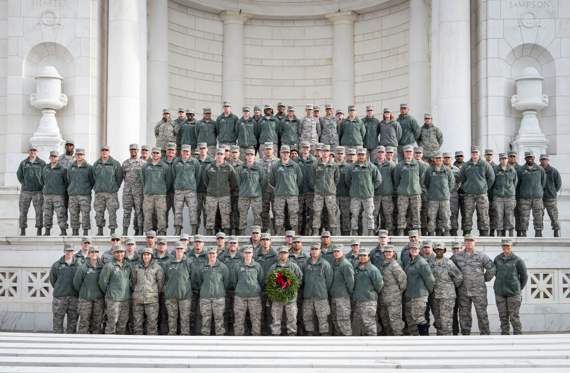 Approximately 150 volunteers from Dover Air Force Base, Delaware, pose for a group photo upon completing their volunteer work with Wreaths across America at Arlington National Cemetery, Dec. 13, 2014. The Dover Airmen joined thousands of service members, veterans and civilians to help place holiday wreaths on graves throughout the cemetery. (U.S. Air Force photo/Capt. Ray Geoffroy)