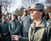 Staff Sgt. Britini Jennie, Airman dormitory leader, instructs approximately 150 volunteers from Dover Air Force Base, Delaware, during Wreaths across America at Arlington National Cemetery, Dec. 13, 2014. Airmen representing various Dover organizations including the Airmen Dorm Council and Air Force Mortuary Affairs Operations helped Wreaths across America place approximately 500,000 holiday wreaths on graves throughout the cemetery. (U.S. Air Force photo/Capt. Ray Geoffroy)