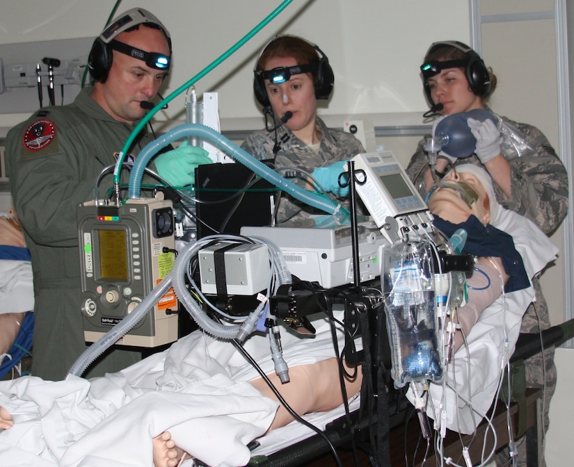 Air Force Capt. Andrew Ray Severns, Air Force Capt. (Dr.) Katherine Ellis and
Air Force Staff Sgt. Jamie Bucher participate in Critical Care Air Transport
Team (CCATT) Simulation Day training in Walter Reed Bethesda simulation
center on Dec. 11. Air Force physicians, nurses and respiratory therapists were able to hone their critical care skills on life-like manikins using virtual reality machines and equipment in the high-tech, state-of-the-art simulation center. (Photo by Bernard S. Little)