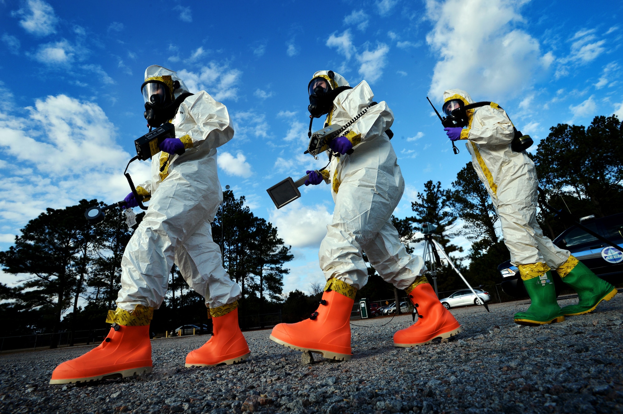 (From left) U.S. Air Force Senior Airman Chantal Hogue and Lauren Yancey, 20th Civil Engineer Squadron emergency management apprentices, and Senior Airman Jordan Gagne, 20th Aerospace Medicine Squadron bioenvironmental engineering journeyman, walk into a simulated contaminated zone during an integrated base emergency response capability exercise at Shaw Air Force Base, S.C., Dec. 9, 2014. The Airmen were the initial entry team and entered the simulated contamination zone fist to test for hazardous materials. (U.S. Air Force photo by Staff Sgt. Kenny Holston/Released)