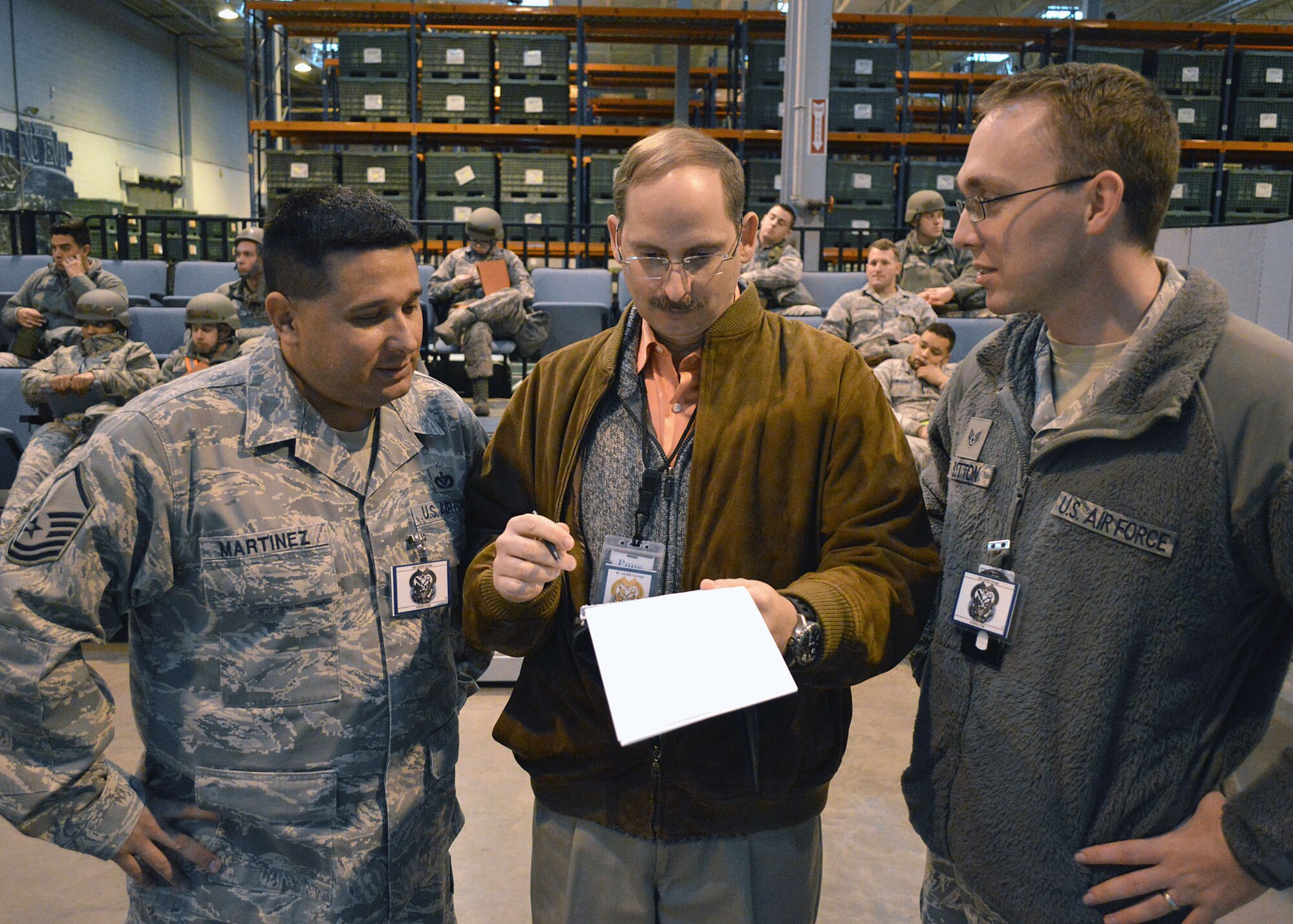 Air Force Master Sgt. Steven Martinez, 43rd Force Support Squadron, left, James McVay, 43rd Airlift Group inspections and exercises, center, and Staff Sgt. Wesley Sutton, 43rd Airlift Group chaplain assistant, all members of the Group’s inspection team, evaluate exercise personnel deployment function operations on Dec. 16 at Pope Army Airfield, North Carolina. The Group participated in a deployment exercise here Dec. 12 thru Dec. 16 as part of the new Air Force Commander’s Inspection Program. The deployment exercise focused on the Group’s ability to deploy over 100 expeditionary Airmen and equipment worldwide on short-notice. Group inspection team members evaluated the exercise to provide constructive feedback on areas of excellence and areas for improvement. The commander’s inspection program is a continual assessment of four major graded areas: managing resources, leading people, improving the unit and executing the mission, allowing the Group to focus on mission readiness and effectiveness. (U.S. Air Force photo/Marvin Krause)