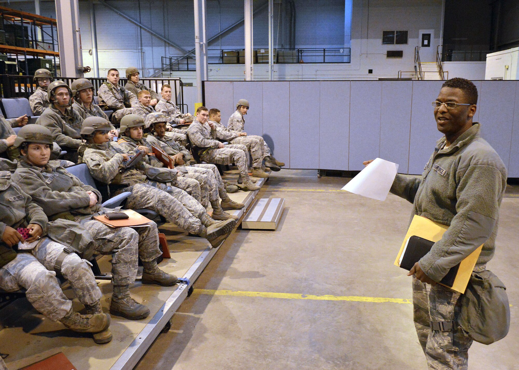 Air Force Senior Master Sgt. Johnny Brown, 43rd Logistics Readiness Squadron, right, provides an exercise personnel accountability briefing as the troop leader for deploying personnel on Dec. 16 at Pope Army Airfield, North Carolina. The Group participated in a deployment exercise here Dec. 12 thru Dec. 16 as part of the new Air Force Commander’s Inspection Program. The deployment exercise focused on the Group’s ability to deploy over 100 expeditionary Airmen and equipment worldwide on short-notice. The troop leader must account for and control the deploying force from the time after processing through the personnel deployment function until arrival at the final deployed location. (U.S. Air Force photo/Marvin Krause)