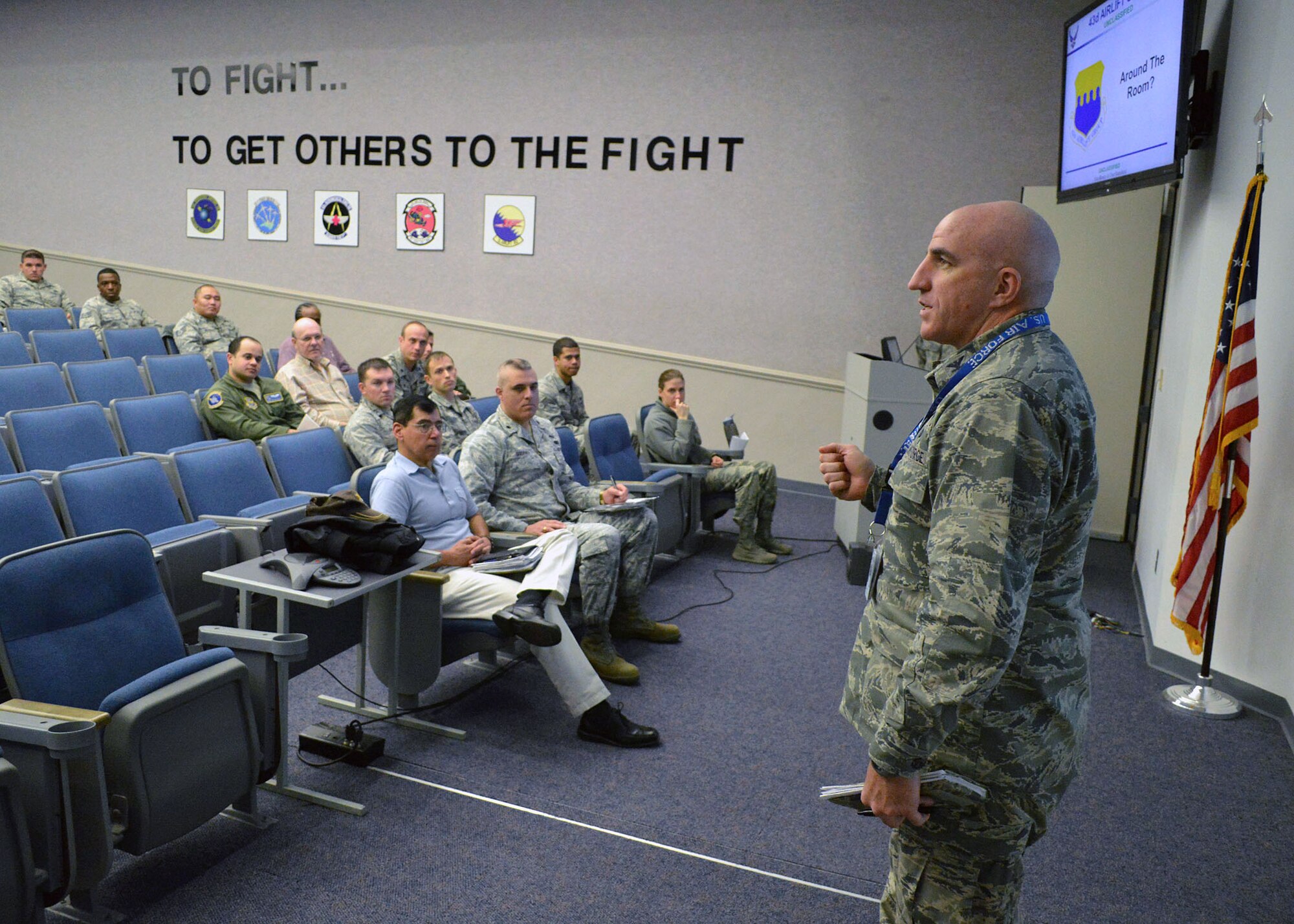 Air Force Col. Kenneth Moss, 43rd Airlift Group commander, provides comments during an exercise deployment concept briefing to 43rd Airlift Group senior leadership, unit commanders, deployment workcenter supervision and unit deployment managers on Dec. 15 at Pope Army Airfield, North Carolina. The Group participated in a deployment exercise here Dec. 12 thru Dec. 16 as part of the new Air Force Commander’s Inspection Program. The deployment exercise focused on the Group’s ability to deploy over 100 expeditionary Airmen and equipment worldwide on short-notice. The concept briefing sets the tone for the exercise deployment and ensures all deploying and support units understand the tasking, the deployment schedule, and critical employment site information that could affect the mission, health, and safety of deploying personnel. (U.S. Air Force photo/Marvin Krause)