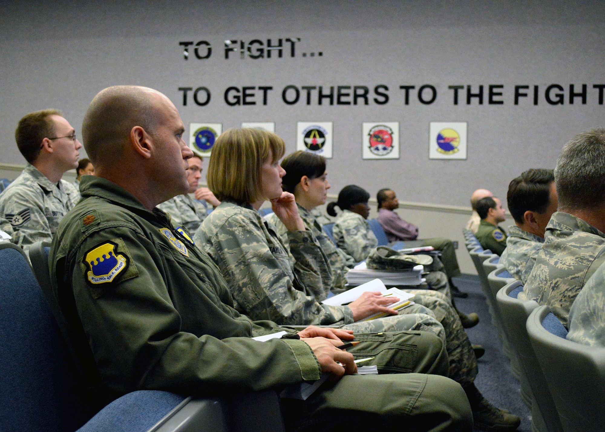 43rd Airlift Group senior leadership, unit commanders, deployment workcenter supervision and unit deployment managers listen to an exercise deployment concept briefing provided by Air Force 1st Lt. Yunior Soto, installation deployment officer from the 43rd Logistics Readiness Squadron on Dec. 15 at Pope Army Airfield, North Carolina. The Group participated in a deployment exercise here Dec. 12 thru Dec. 16 as part of the new Air Force Commander’s Inspection Program. The deployment exercise focused on the Group’s ability to deploy over 100 expeditionary Airmen and equipment worldwide on short-notice. (U.S. Air Force photo/Marvin Krause)