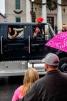 Col. Mark Slocum, 4th Fighter Wing commander, waives to the crowd from an Explosive Ordnance Disposal vehicle during the annual holiday parade in Goldsboro, North Carolina, Dec. 6, 2014. Slocum, accompanied by Master Sgt. Christopher Wakham and Airman 1st Class Zackery Logan, both of the 4th Civil Engineer Squadron EOD flight, was the Grand Marshal of the parade which had more than 100 participants, including floats, walking groups, fire stations, marching bands, color guards and civic groups. (U.S. Air Force photo/Airman Shawna L. Keyes)  