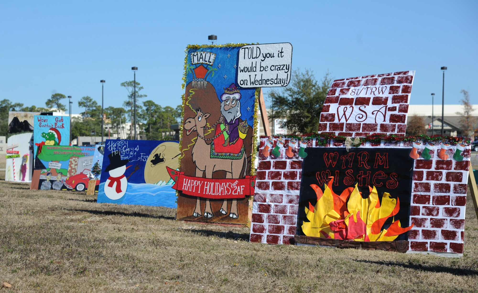 Oversized handcrafted holiday cards created for the Squadron Holiday Card Contest sit on display along Larcher Blvd. in front of the base exchange Dec. 16, 2014, at Keesler Air Force Base, Miss.  The contest, sponsored by the 81st Force Support Squadron, will be judged Dec. 18 in the following categories: most charismatic, innovative and classic. (U.S. Air Force photo by Kemberly Groue)