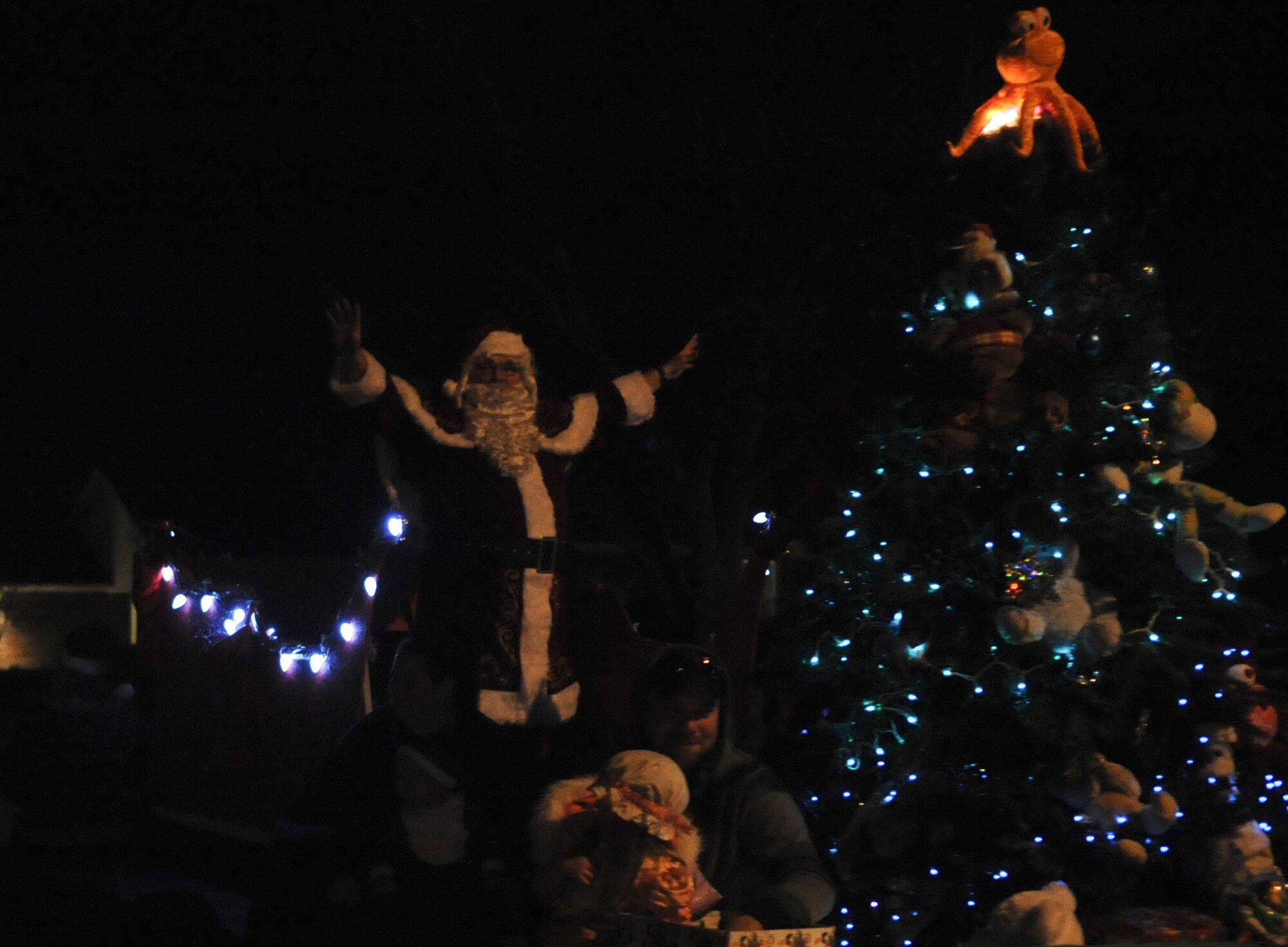 Santa Claus waves to members of Team Seymour during the Santa Parade at Seymour Johnson Air Force Base, North Carolina, Dec. 13, 2014. The parade featured vehicles from several base agencies, dozens of volunteers passing out candy, and the Grinch in a cage of holiday lights. (U.S. Air Force photo/Senior Airman Ashley J. Thum)  