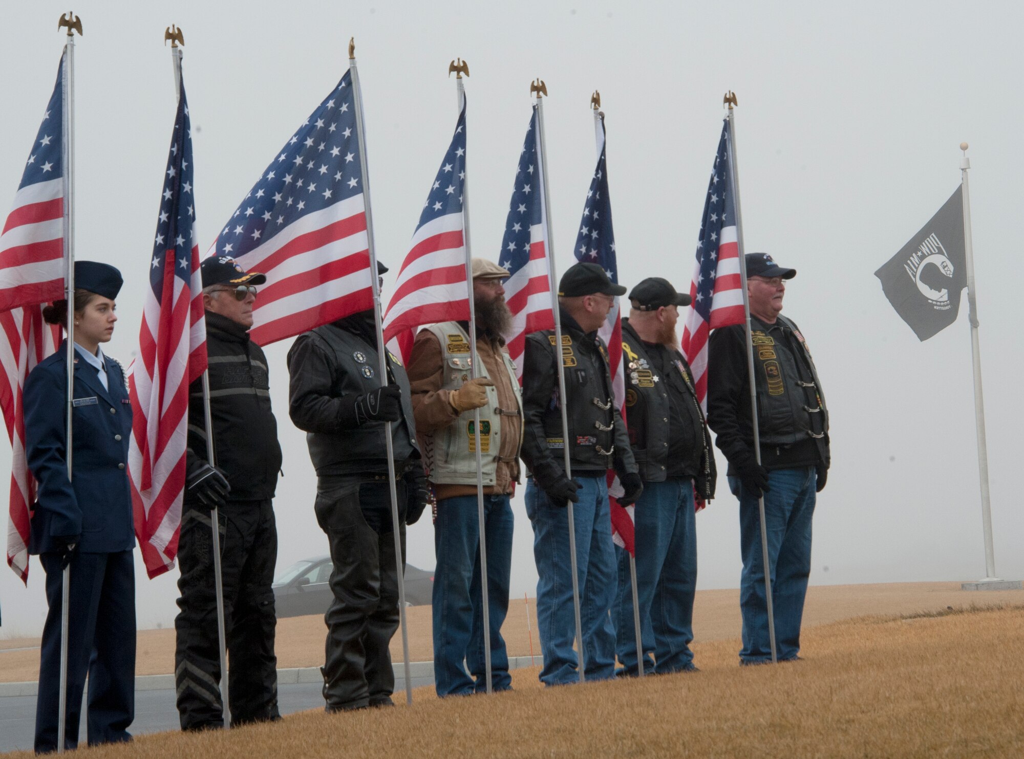 The Patriot Guard Riders hold flags in remembrance of fallen heroes during the Wreath Across America event, Dec. 13, 2014 at the Washington State Veterans Cemetery in Medical Lake, Wash. Fairchild Airmen, the Spokane and Medical Lake Community and families and friends of fallen heroes gather to place wreaths upon veteran’s burial stones in support of the event. (U.S. Air Force photo/Airman 1st Class Nicolo J. Daniello)