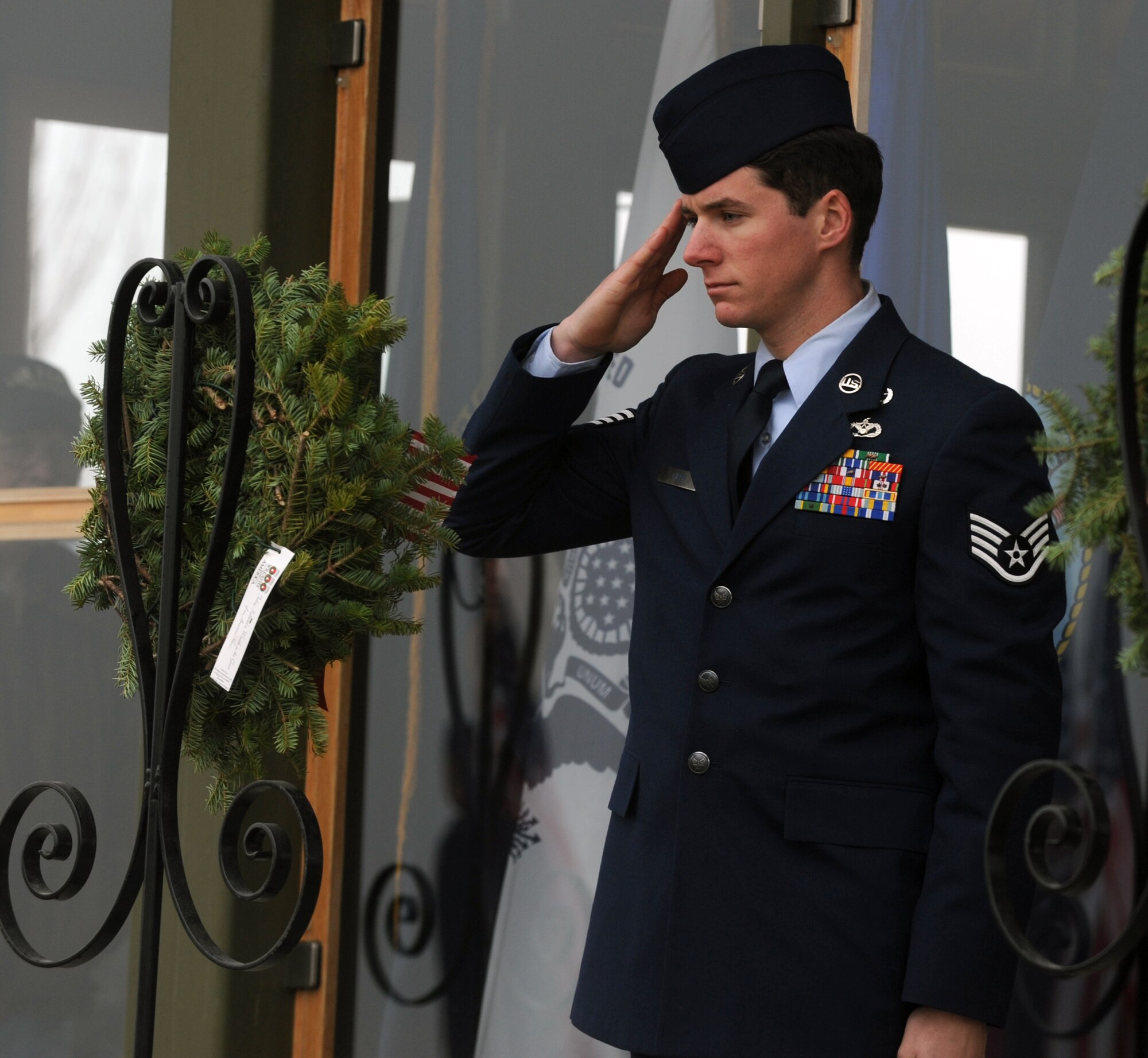 Staff Sgt. Daniel Hipps, 92nd Civil Engineer Squadron explosive ordinance disposal technician, salutes a wreath representing the U.S. Air Force Dec. 13, 2014 during the Wreaths Across America event at the Washington State Veterans Cemetery in Medical Lake, Wash. The event happens annually and is designed to spread the message about the importance of remembering fallen heroes, honoring those who served and teaching children about the sacrifices made by veterans and their families to preserve freedom. (U.S. Air Force photo/Staff Sgt. Samantha Krolikowski)