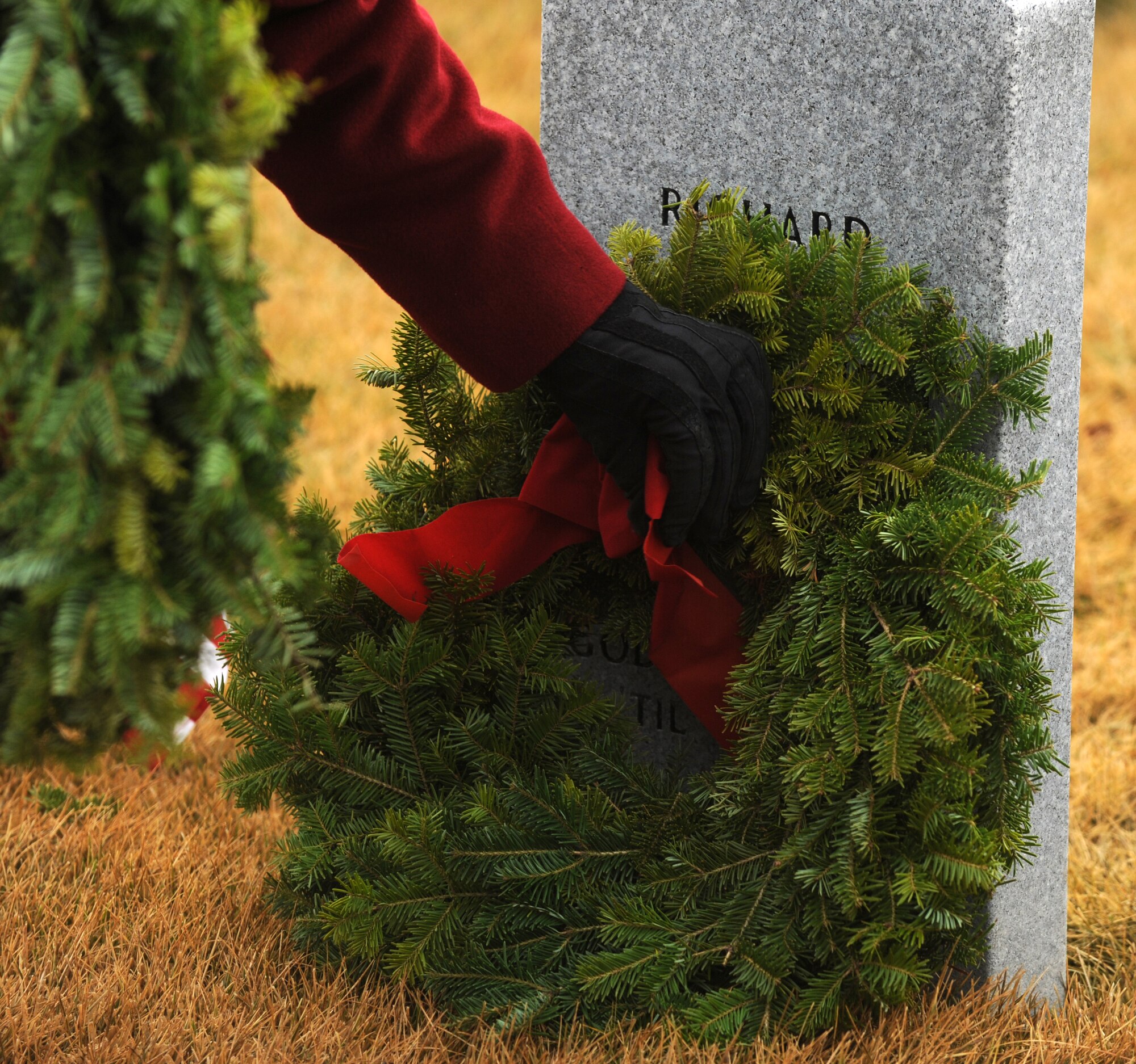 A wreath is placed beside a burial stone Dec. 13, 2014, at Washington State Veterans Cemetery in Medical Lake, Wash. The Wreaths Across America event is designed to remember fallen heroes, honor those who served and teach children about the sacrifices made by veterans and their families to preserve freedom. (U.S. Air Force photo/Staff Sgt. Samantha Krolikowski)