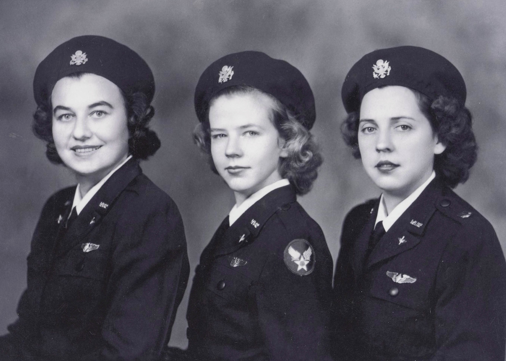 Young Flora Belle (Smith) Reece is shown between fellow classmates after graduating from B-26 school in Harlington, Texas. Reece was younger than her classmates because she entered the service at 19 when the minimum age was 21. (U.S. Air Force photo)