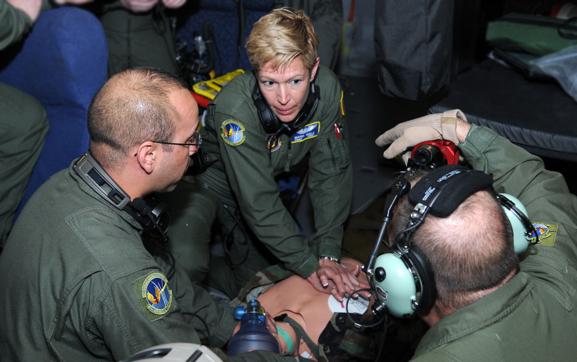 Aeromedical technicians Tech. Sgt. Maria Aval and Staff Sgt. F. Javier Magana, both aeromedical technicians with the 45th AES, MacDill AFB, Florida, administer first aid to a simulated cardiac arrest patient during a three-day training mission held Dec. 12, 2014. To stay proficient at their lifesaving skills, the technicians routinely climb aboard a MacDill based KC-135 to fine tune their caregiving skills. (U.S. Air force photo/Tech. Sgt. Peter Dean/released)