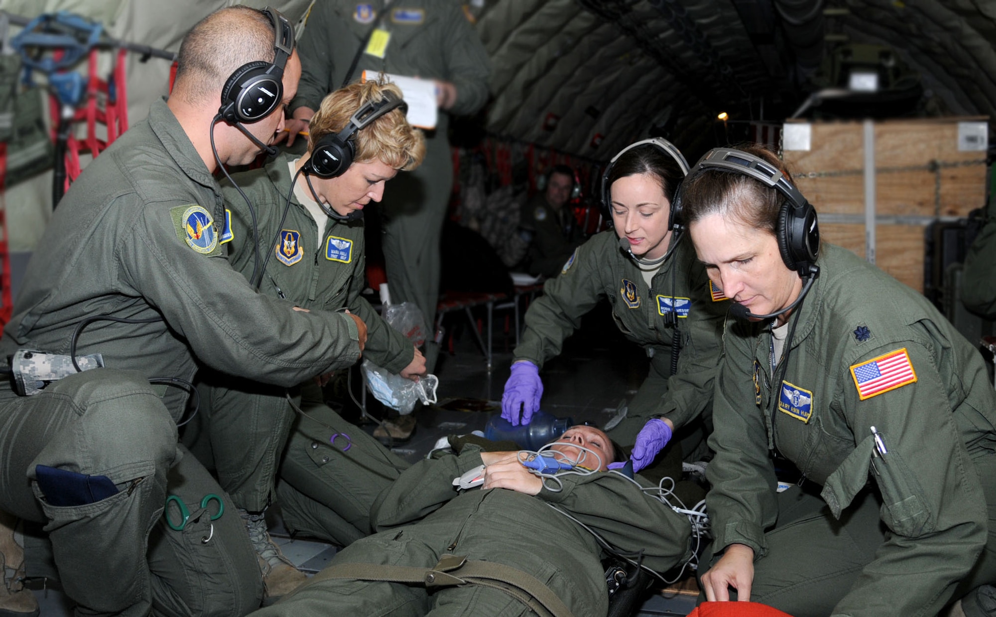 Aeromedical technicians from the 45th AES, MacDill AFB, Florida, respond to a simulated inflight medical emergency during a three-day training mission held Dec. 12, 2014. To stay proficient at their lifesaving skills, the technicians routinely climb aboard a MacDill based KC-135 to fine tune their caregiving skills. (U.S. Air force photo/Tech. Sgt. Peter Dean/released)