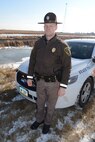 Master Sgt. Grant Lonski, of the 119th Security Forces Squadron, visits the accident scene that he responded to while performing his full-time North Dakota Highway Patrol duties near Churchs Ferry, N.D., Nov. 18, 2014. On Nov. 12, 2014, Lonski was able to pull 81-year-old accident victim Merti Kurtti from freezing cold water in the ditch behind him in this photo. (U.S. Air Force photo/Senior Master Sgt. David Lipp)