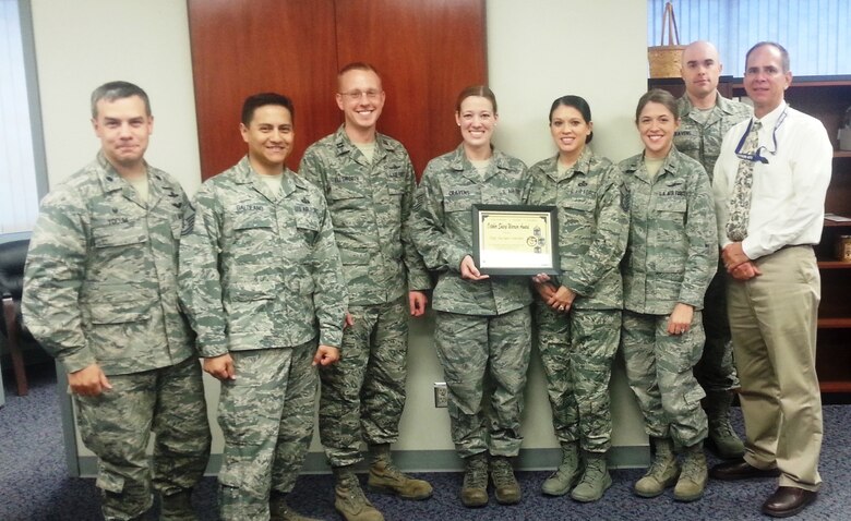 PETERSON AIR FORCE BASE, Colo. -- Members of the Pikes Peak Top 3 present the October 2014 Sharp Warrior Award to Tech. Sgt. Jaclyn Cravens, 721st Mission Support Group. Cravens leads a 20-member Wing Readiness Inspection Team for Cheyenne Mountain Air Force Station, responsible for the planning, organization and evaluation of readiness factors. As the 721st MSG safety representative, she prepared the installation for a Wing evaluation, mentored unit monitors and led the mission support group to an “Excellent” rating. Additionally, she planned and organized all readiness scenarios for Exercise Vigilant Shield 2015. Cravens has consistently demonstrated exceptional dedication and proficiency in her duties, and professionalism on and off duty, leading to her selection as the Sharp Warrior. (U.S. Air Force photo)
